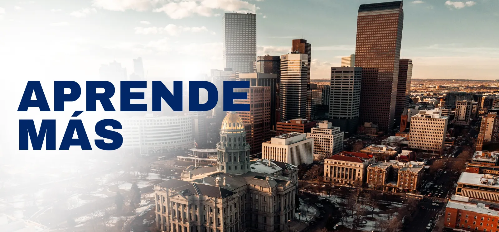 "Aprende mas" superimposed over the Denver skyline