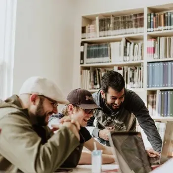 Workers huddled around a laptop